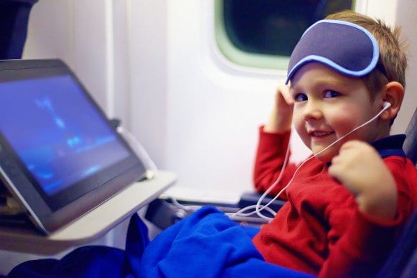 Child with tablet on airplane